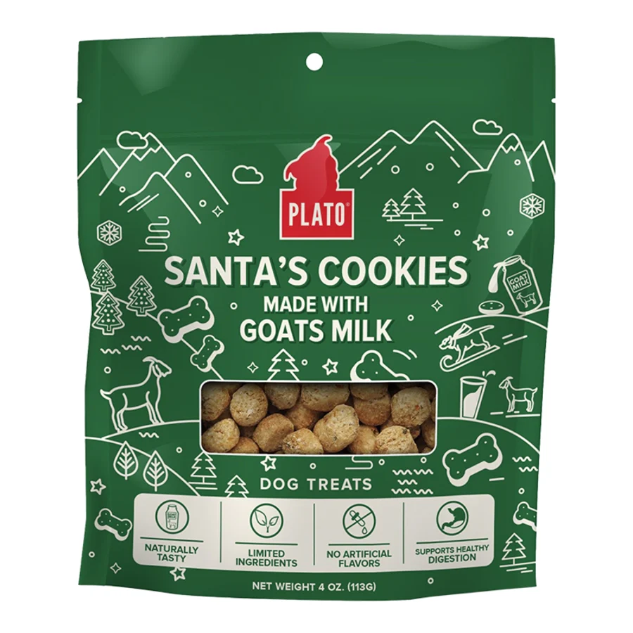 A green bag of Plato's Santa's Cookies dog treats made with goat's milk. The packaging features holiday-themed graphics, including trees and snowflakes, and highlights benefits such as natural ingredients and digestion support. Net weight: 4 oz (113g).