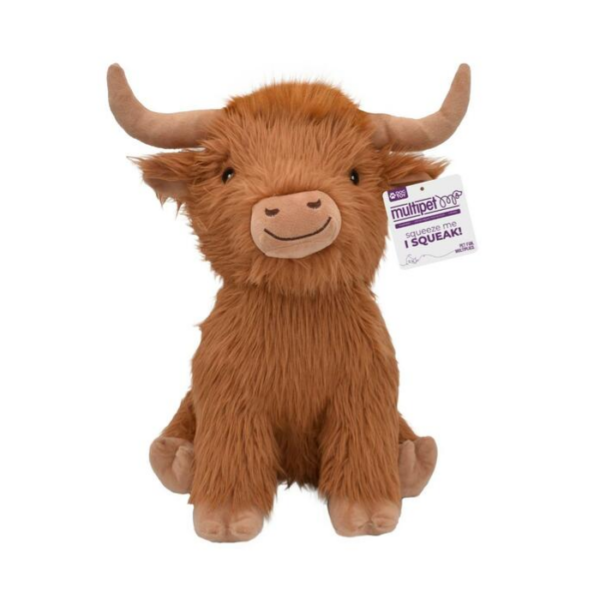 A brown, plush Highland cow toy with long fur, two curved horns, a smiling face, and a tag attached to its ear that says "multipet nob SQUEAK." The toy is sitting upright against a white background.