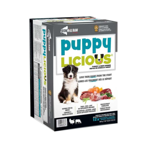 A box of Iron Will Raw Puppy Licious pet food featuring a black and white puppy on the front. The box promotes ingredients like turkey, beef, and bone, and claims to support overall growth and development. The text is in both English and French.