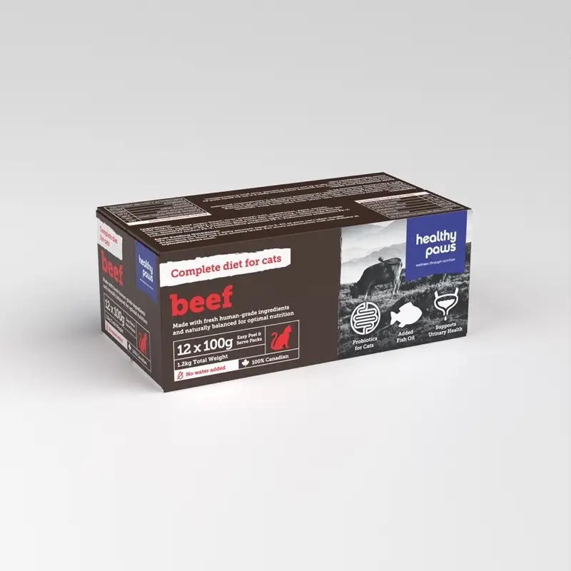 A rectangular box of Healthy Paws Beef Complete 12x100g for Cat, labeled as a complete diet. The brown packaging has white and red text, cat images, and icons showing digestion, heart, and urinary health benefits.