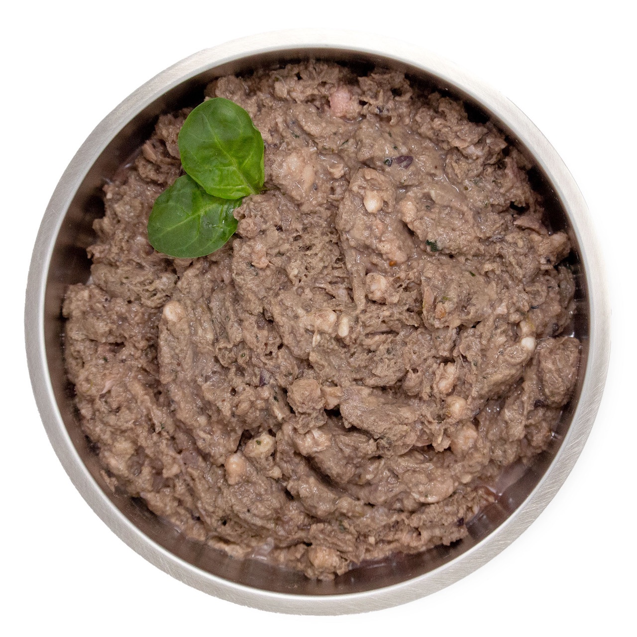 A stainless steel bowl filled with Big Country Raw Lamb Dinner 4x1lb chunky wet pet food, topped with two small green leaves, viewed from above against a white background.