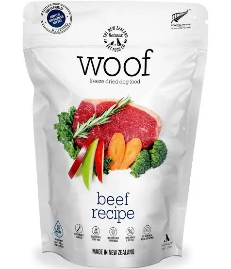 A 50g bag of Freeze Dried Woof Beef dog food, featuring a beef recipe. The packaging displays images of beef, carrots, broccoli, and rosemary, along with “Made in New Zealand” and certification logos at the top.