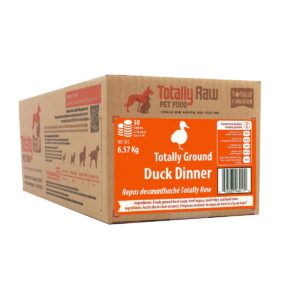 A cardboard box labeled “Totally Raw Ground Duck Patty 15lbs” from Totally Raw Pet Food features orange accents, a detailed ingredients list, and nutritional information.