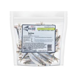 A clear plastic stand-up pouch of Iron Will Raw Sardines 1 lb, filled with whole raw sardines and featuring a product label with feeding instructions and guaranteed analysis.