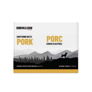 A square box of Iron will Raw Basic Pork 6 lb pet food featuring a landscape illustration of mountains and a dog, labeled “Pork” and “Porc” in English and French.