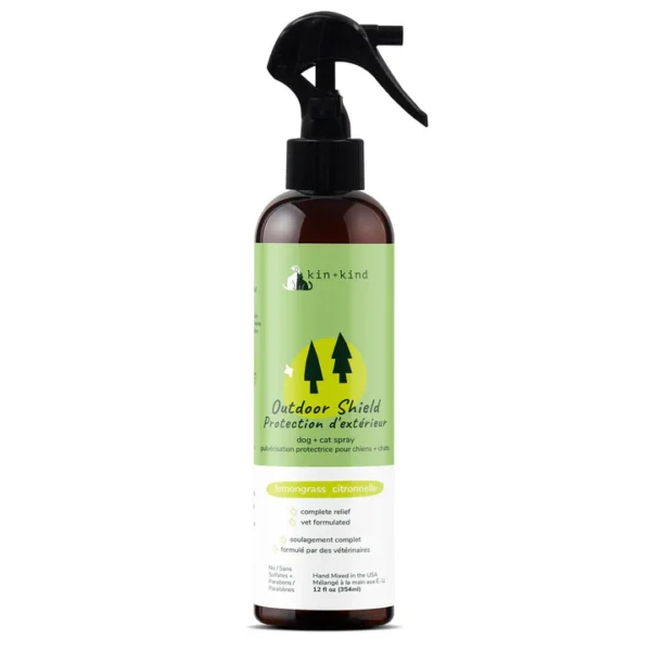 The Kin + Kind Outdoor Shield Spray for Dog 12 oz features a black nozzle and light green label with tree illustrations. Infused with invigorating lavender scent, this spray is perfect for outdoor protection, designed to shield your pets with care.