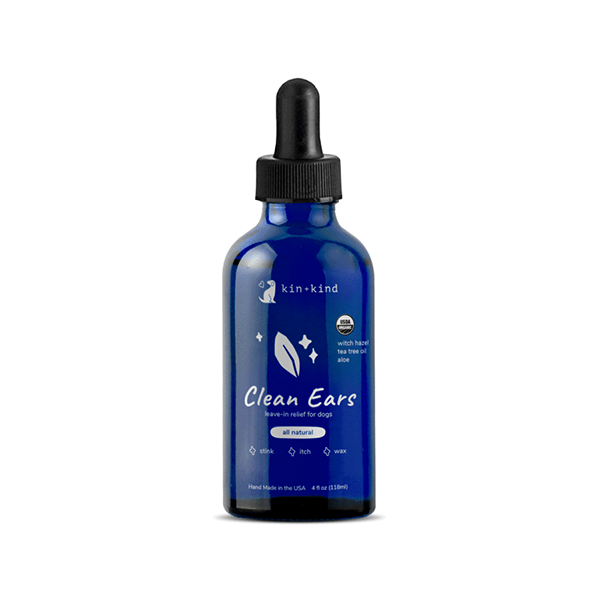 Blue bottle of "kin+kind Clean Ears" ear cleaner for pets, with a black dropper cap. The label features leaf graphics and text indicating it's all-natural and made in the USA. The bottle size is 4 fl oz (118 ml).