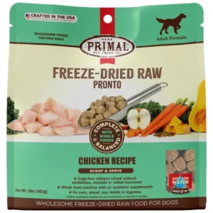 A package of Primal Freeze-Dried Raw Pronto dog food in chicken flavor. The front shows a spoon with food, raw chicken pieces, and vegetables. Features include "Complete & Balanced" and "Just Add Water." Made in the USA. Weight: 16 oz (453g).