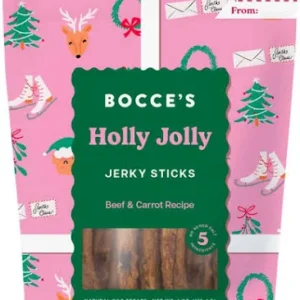 A pink bag of Bocce’s Holly Jolly Jerky Sticks dog treats with reindeer, wreath, and letter illustrations. The label reads "Beef & Carrot Recipe" and there are gift tag spaces for "To" and "From.