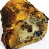 A close-up shows a slice of traditional British spotted dick beside Artisan Smoked Marrow Bone, highlighting the pudding’s golden-brown crust and speckled inside against a white backdrop.