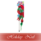 A festive holiday cat toy wand with red, green, and blue plush shapes, displayed in packaging. Below is a red ribbon banner with the text “Holiday Noël” in elegant white script.