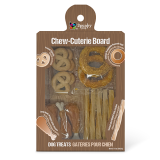 A package labeled "Chew-cuterie Board" containing a variety of dog treats shaped like pretzels, sticks, and bones, displayed on a wooden-patterned background.