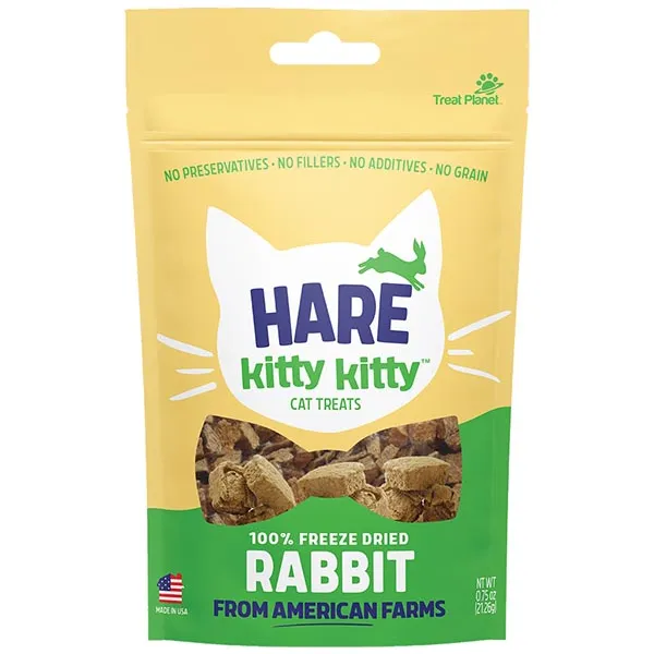 A yellow and green bag of Hare Kitty Kitty cat treats with rabbit flavor, featuring a cat-ear shape, product name, and visible treats through a clear window. Text highlights freeze-dried rabbit and no additives.