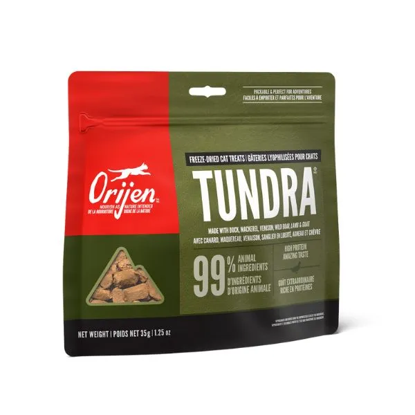 Packaging of Orijen Tundra dog treats, featuring a green and brown design. It highlights "Freeze-Dried Cat Treats" with 99% animal ingredients, showing a combination of duck, mackerel, and more. The net weight is 35g (1.25oz).