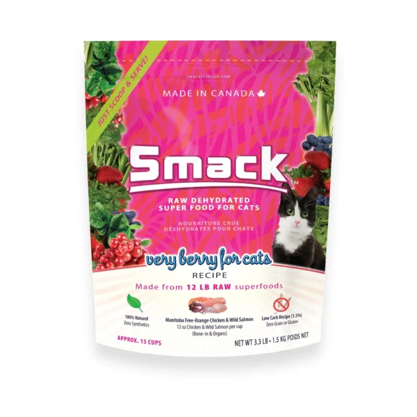 A bag of Smack raw dehydrated superfood for cats, featuring the "Very Berry for Cats" recipe made from 12 lbs of raw superfoods. The bag shows images of berries, greenery, and a black and white cat. It is made in Canada and includes phrases like "100% natural" and "just add water.